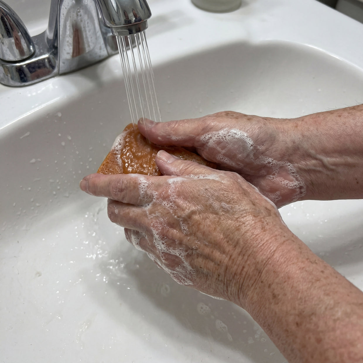 Hands cutting a soap loaf